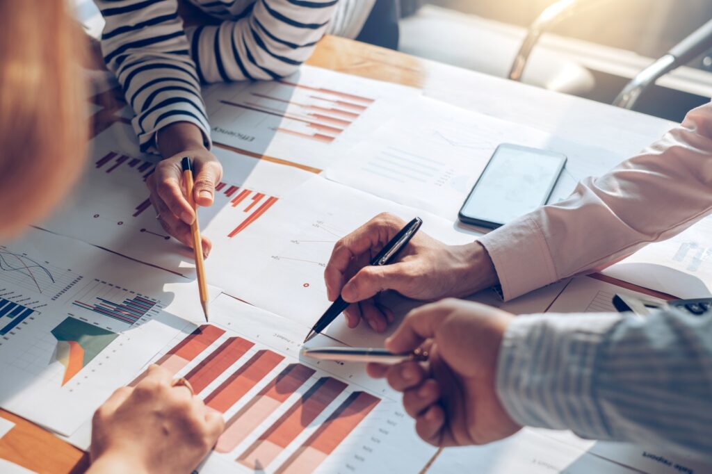Business people discussion and summary financial information at meeting.
