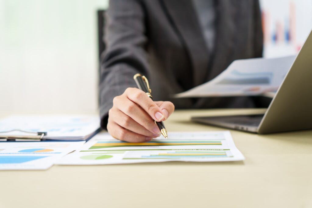 Businesswoman in a grey suit works from home, specializing in policy and planning analysis